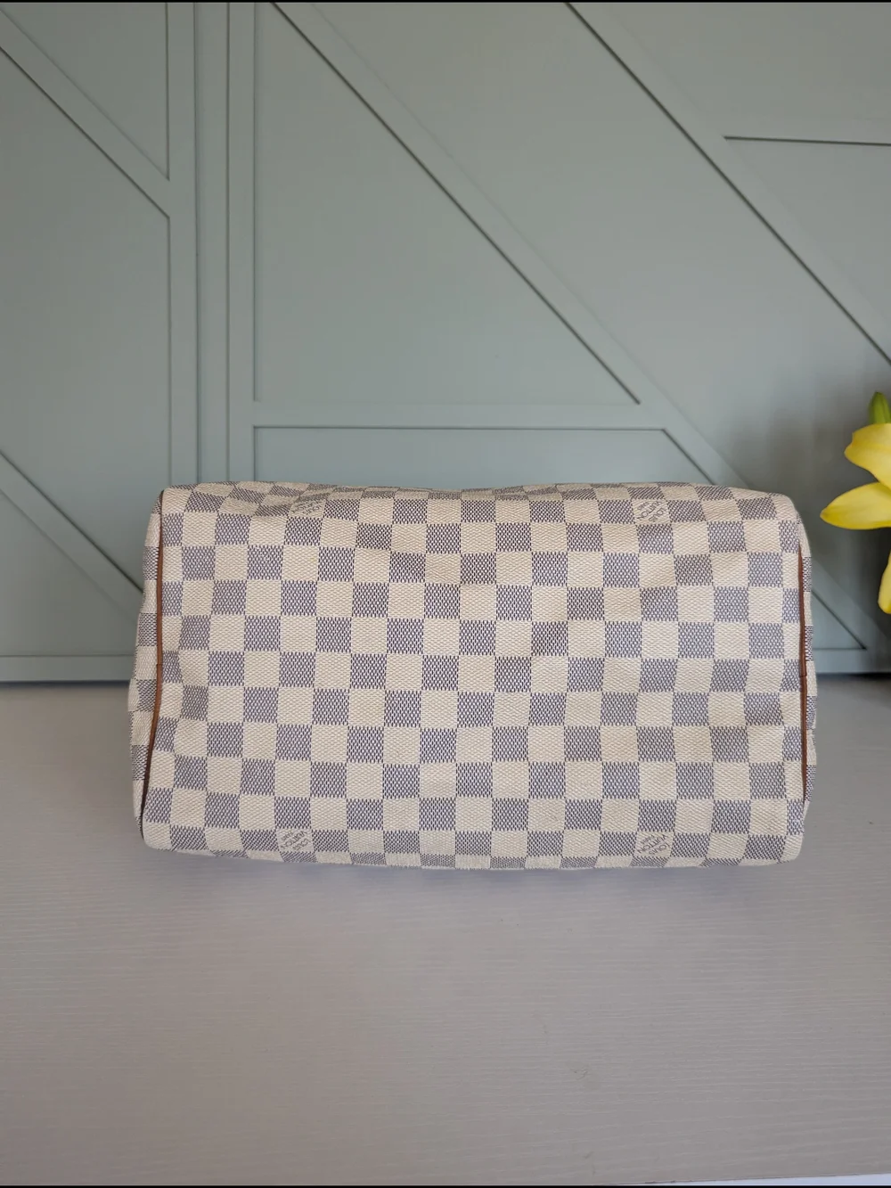 Louis Vuitton Speedyhandbag styled in the iconic Damier Azur canvas pattern.